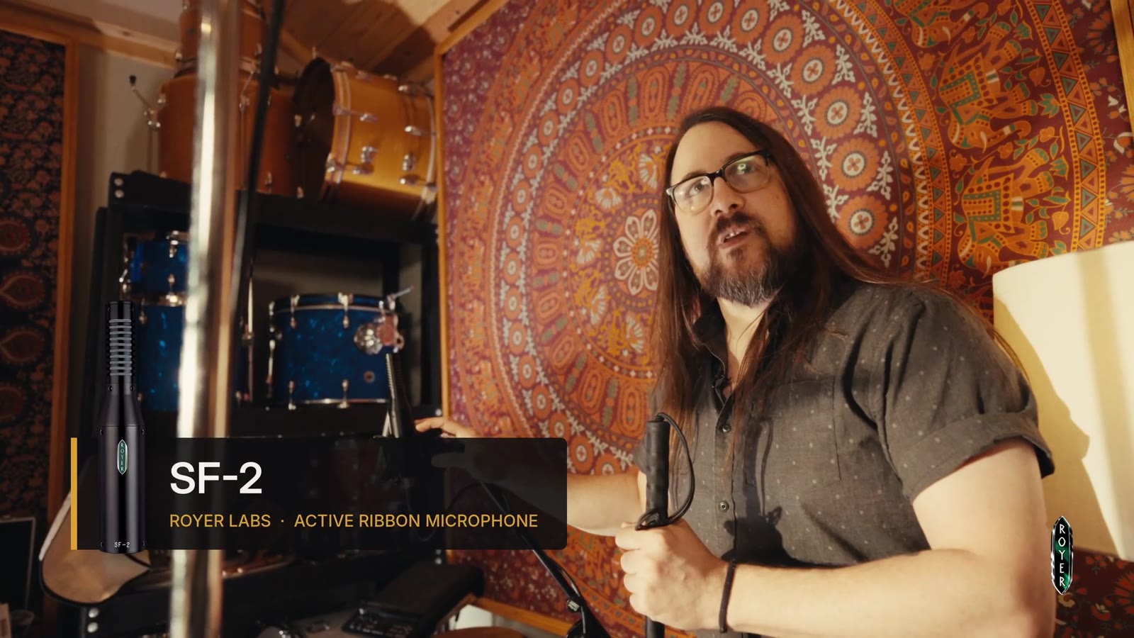 Bobby Holland holding a shaker in front of a Royer SF-2 active ribbon microphone