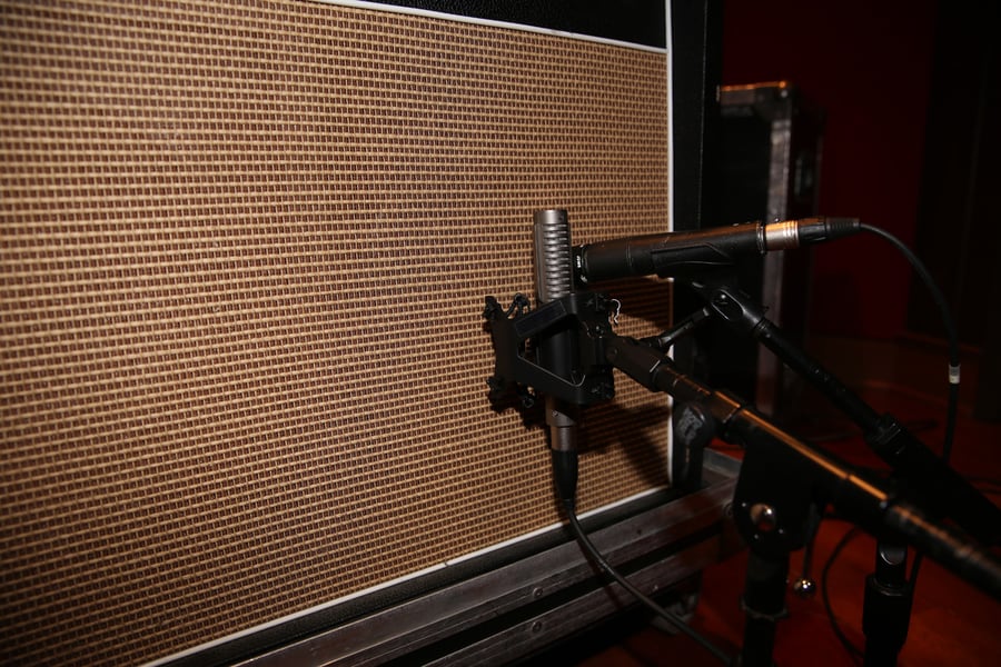R-121 and SM57 side by side on a guitar speaker