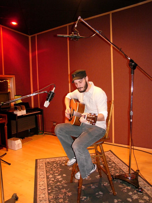 SF-24 overhead above an acoustic guitarist with a large diaphragm condenser in front of the guitar