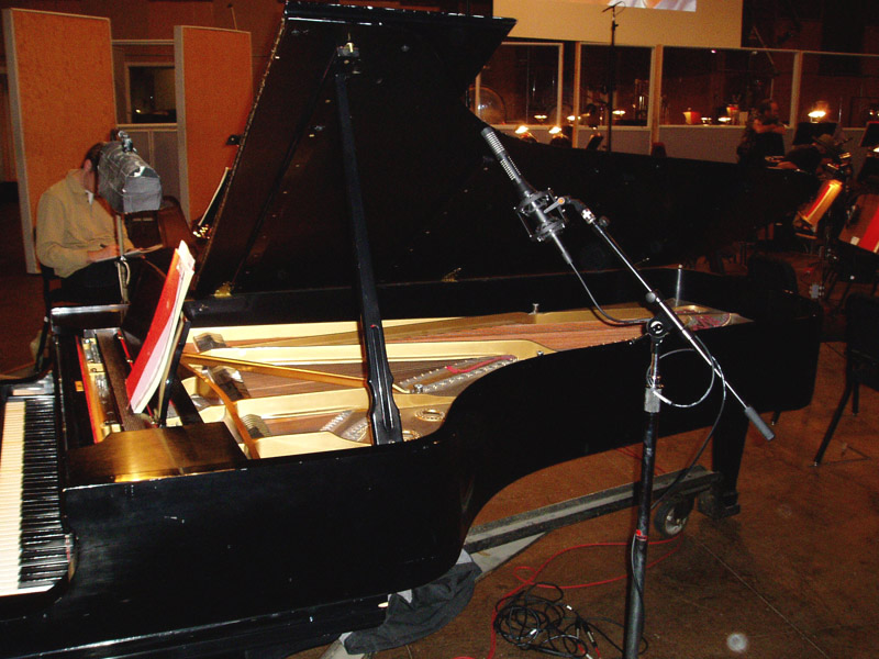 SF-24 stereo ribbon mic just outside the open lid of a grand piano, leaned forward toward the soundboard
